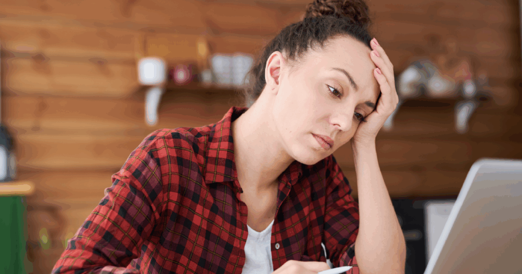 woman looking concerned at laptop